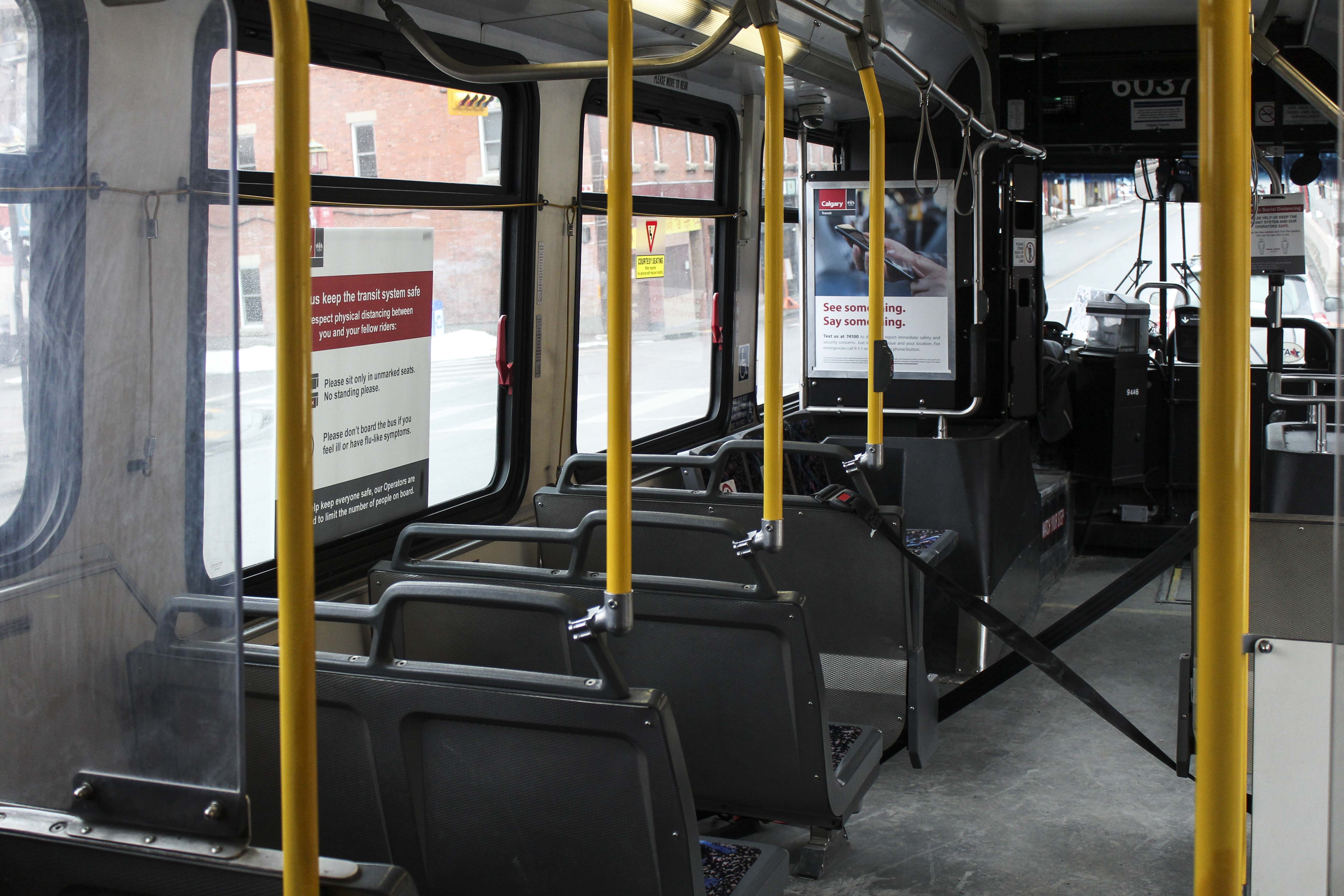 The front rows on Calgary buses are blocked off to protect the driver in the midst of the COVID-19 pandemic on Tuesday, April 7, 2020. A sign on the window reminds people to avoid sitting on prohibited seats for social distancing. (Photo by Meng Wei/SAIT)